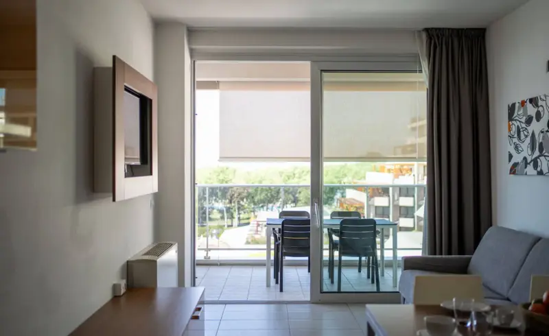 Soggiorno moderno con balcone e mobili eleganti.